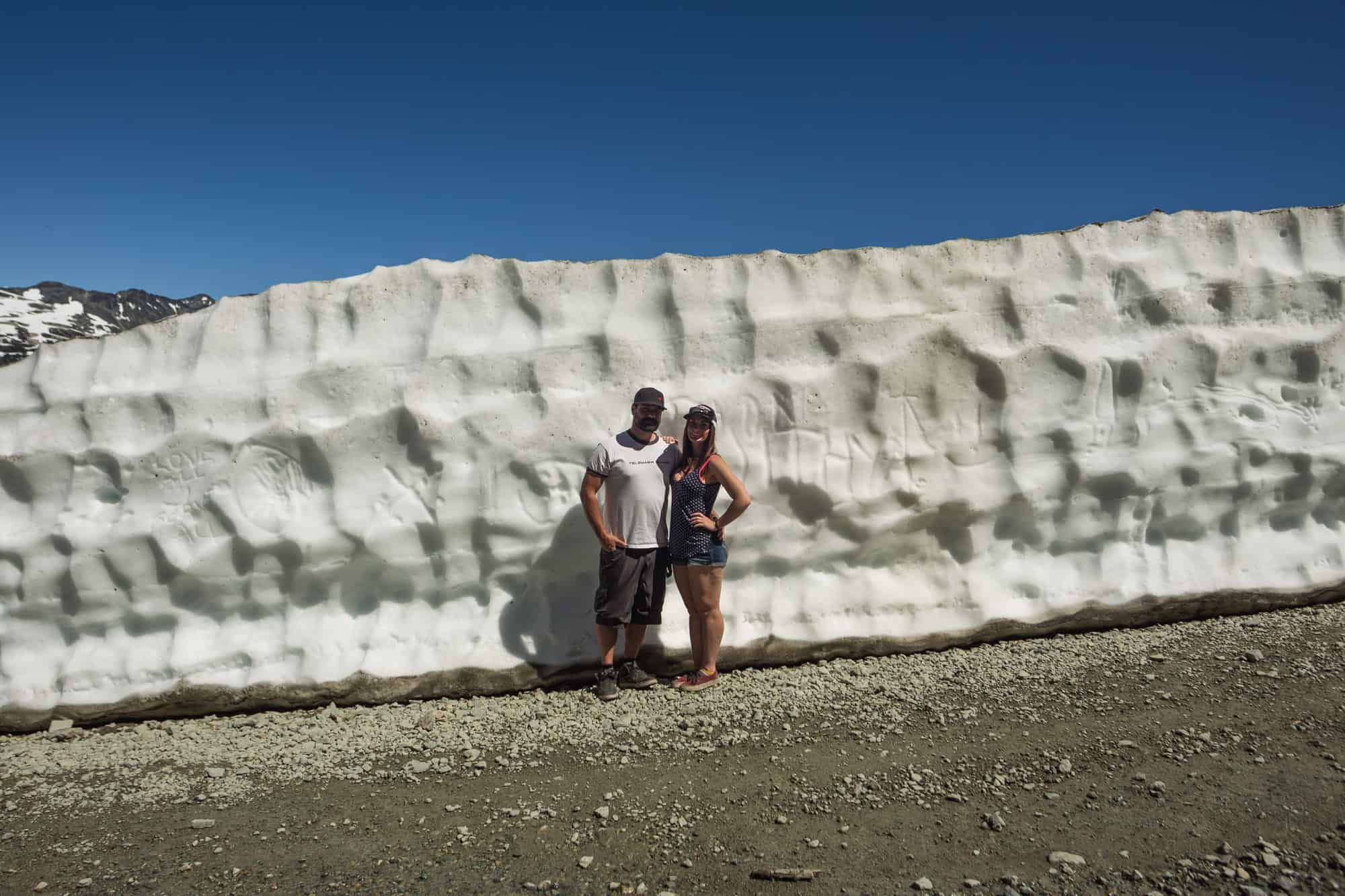 Rachael and Matt standing in front of one of the snow walls on Whistler Mountain.