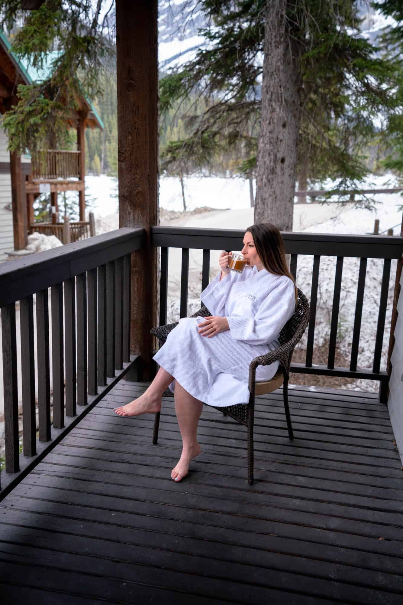 Rachael drinking coffee on the balcony of a room at the Emerald Lake Lodge in Yoho National Park. 