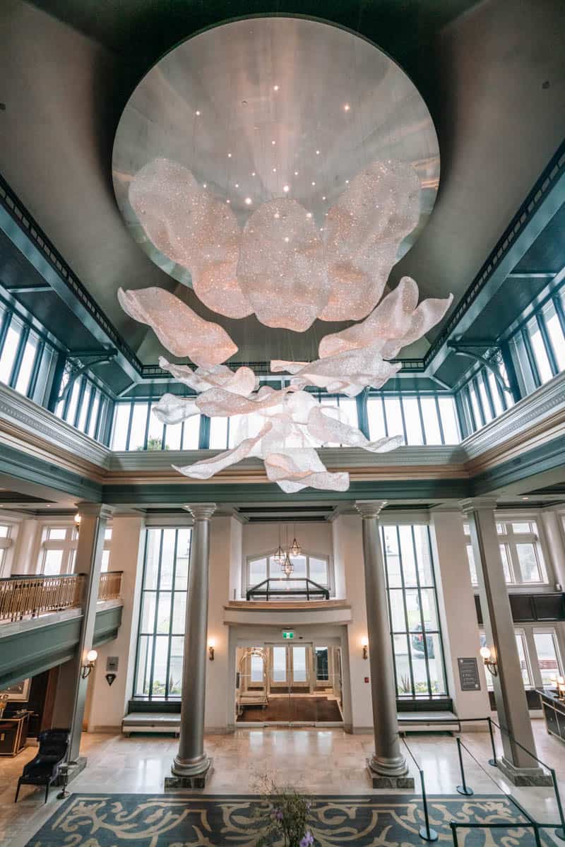 Lobby of the Empress Fairmont Hotel in Victoria BC with it's high ceilings and chandelier filled with thousands of sparkling crystals. 