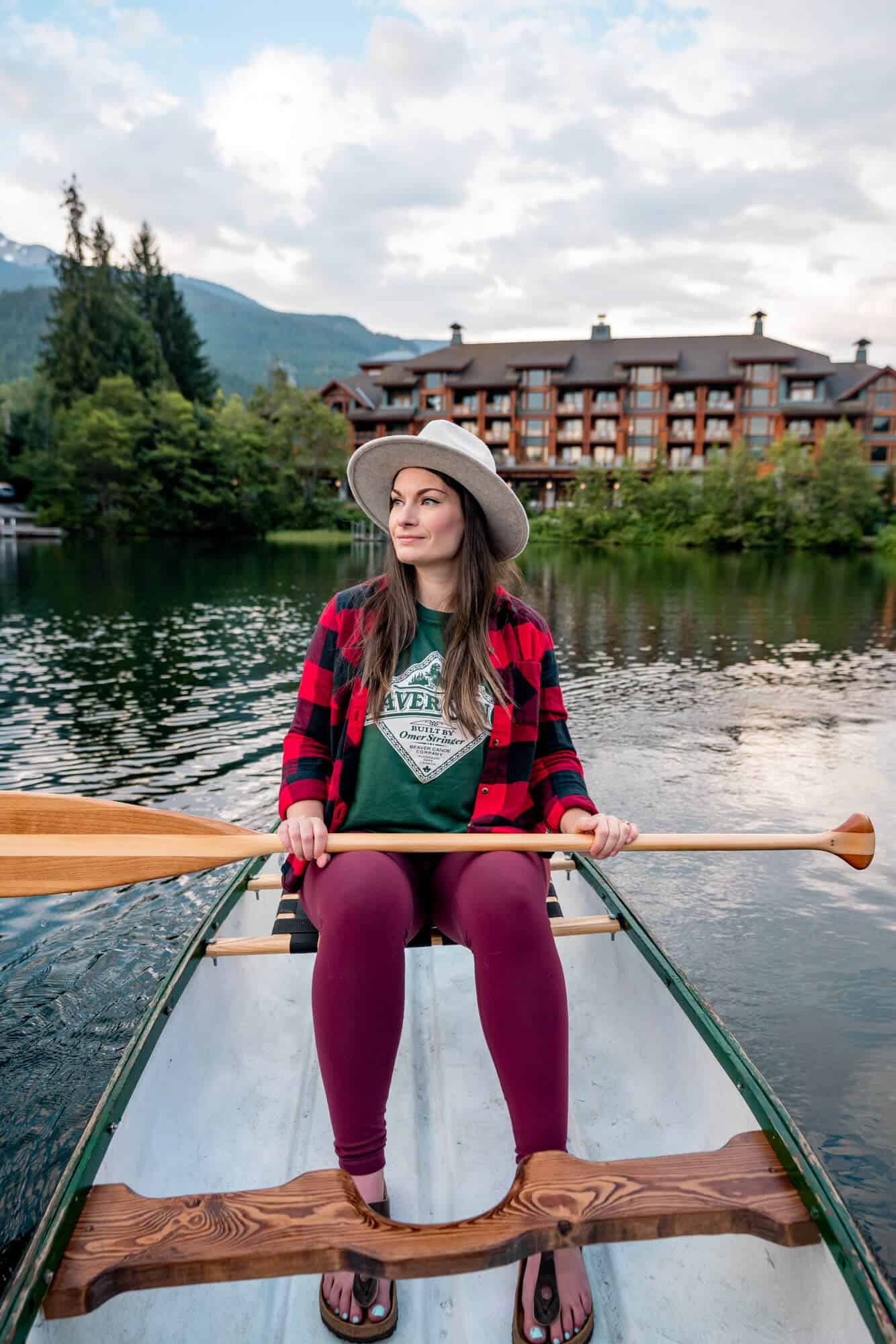 Rachael canoeing on Nita Lake with Nita Lake Lodge in the background.