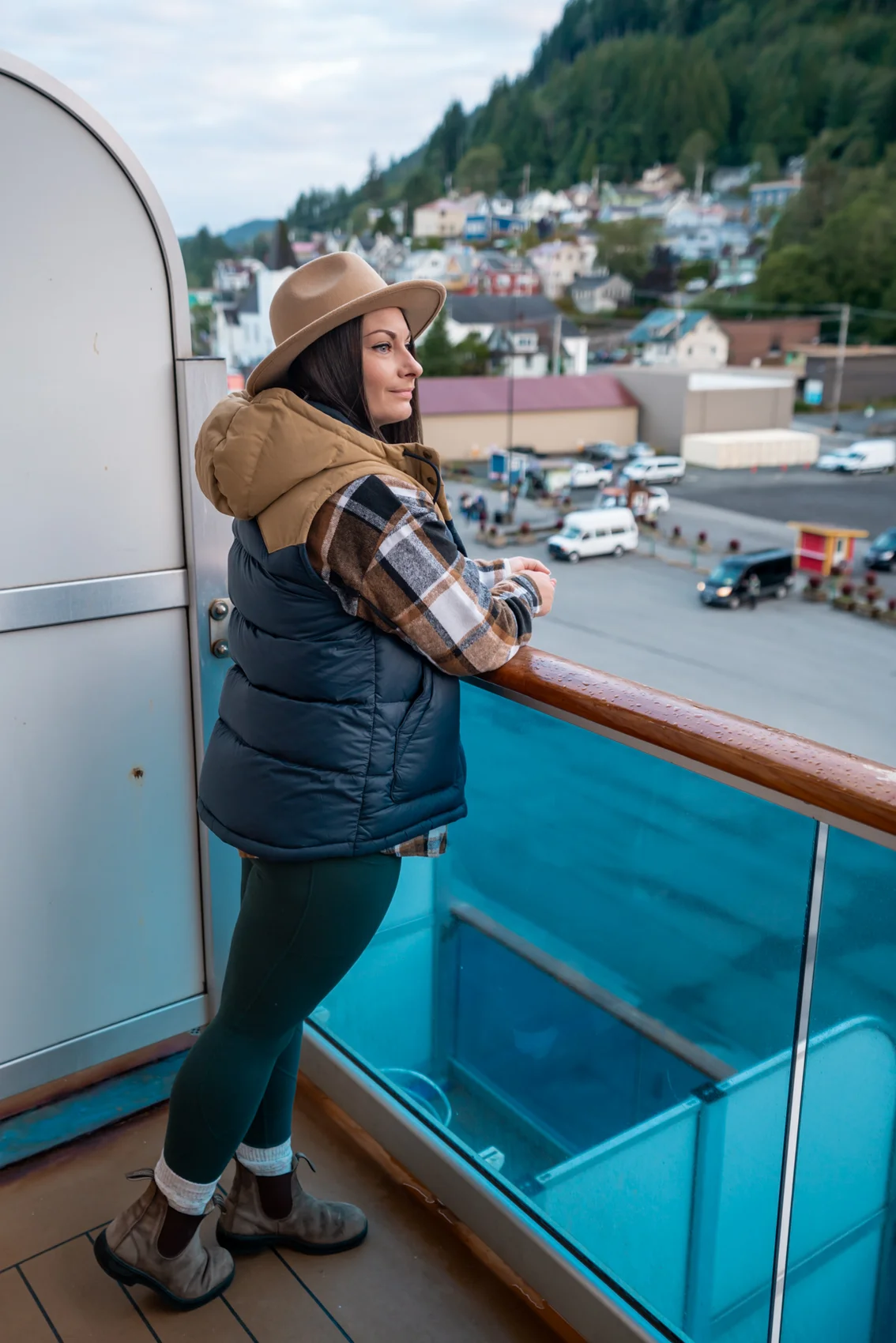 Rachael standing on a stateroom balcony when docked in Ketchikan, Alaska. 