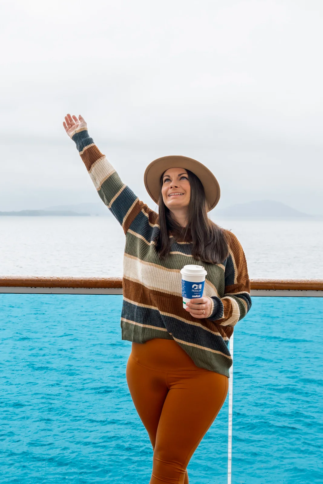 Rachael standing on the balcony during an Alaska cruise.
